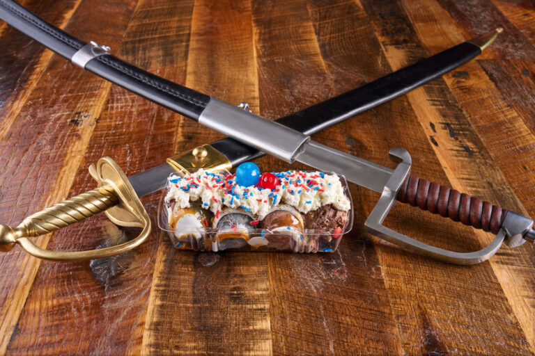 Classic ice cream sundae topped with whipped cream and a cherry.